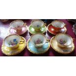 A Tillowitz Dresden porcelain harlequin part set of six cups and saucer with hand painted floral