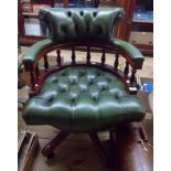 A modern reproduction mahogany framed captain's swivel chair upholstered in studded button back