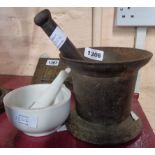 A cast iron pestle and mortar - sold with another