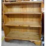 A pair of 96.5cm Ducal polished pine three shelf open waterfall bookcases with moulded decoration,