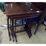 A nest of three reproduction mahogany crossbanded tea tables, set on slender ring turned supports