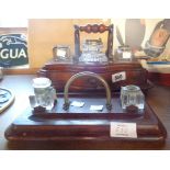 A Victorian walnut inkstand with one original and two associated inkwells - sold with another
