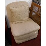 A 20th Century upholstered boudoir nursing chair, set on bun front feet and casters