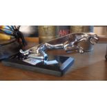 A reproduction jaguar on marble base