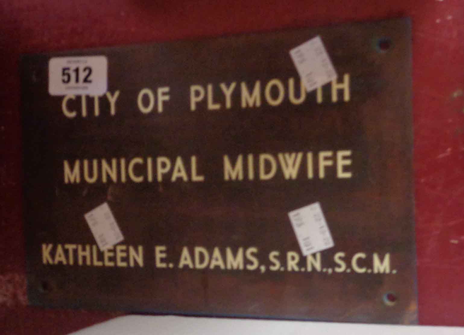 A vintage copper door plaque with inset enamel lettering City of Plymouth Municipal Midwife