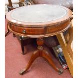 A 51cm diameter reproduction mahogany drum table with green leather inset top and three drawers, set