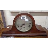 A vintage stained oak cased Napoleon hat mantle clock with eight day chiming movement