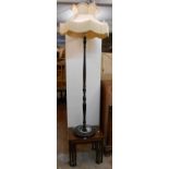 A 20th Century stained wood standard lamp with shade, part reeded pillar and circular base, set on