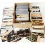 A shoebox containing a collection of plastic sleeved early to mid 20th Century postcards, mainly