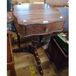 A 46cm reproduction mahogany pedestal table with serpentine top and drawer, set on turned pillar and