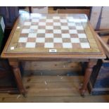 A 54cm reproduction mahogany games/tea table with marbled inset chess board top under glass, set