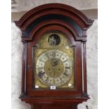 An antique mahogany longcase clock with flanking turned spindles to hood, the 13" arched brass and