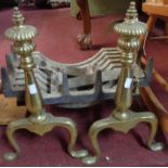 A 20th Century antique style dog fire grate with decorative cast ends with reeded finials, set on