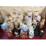 A clowder of seventeen ceramic cat figurines and teapots