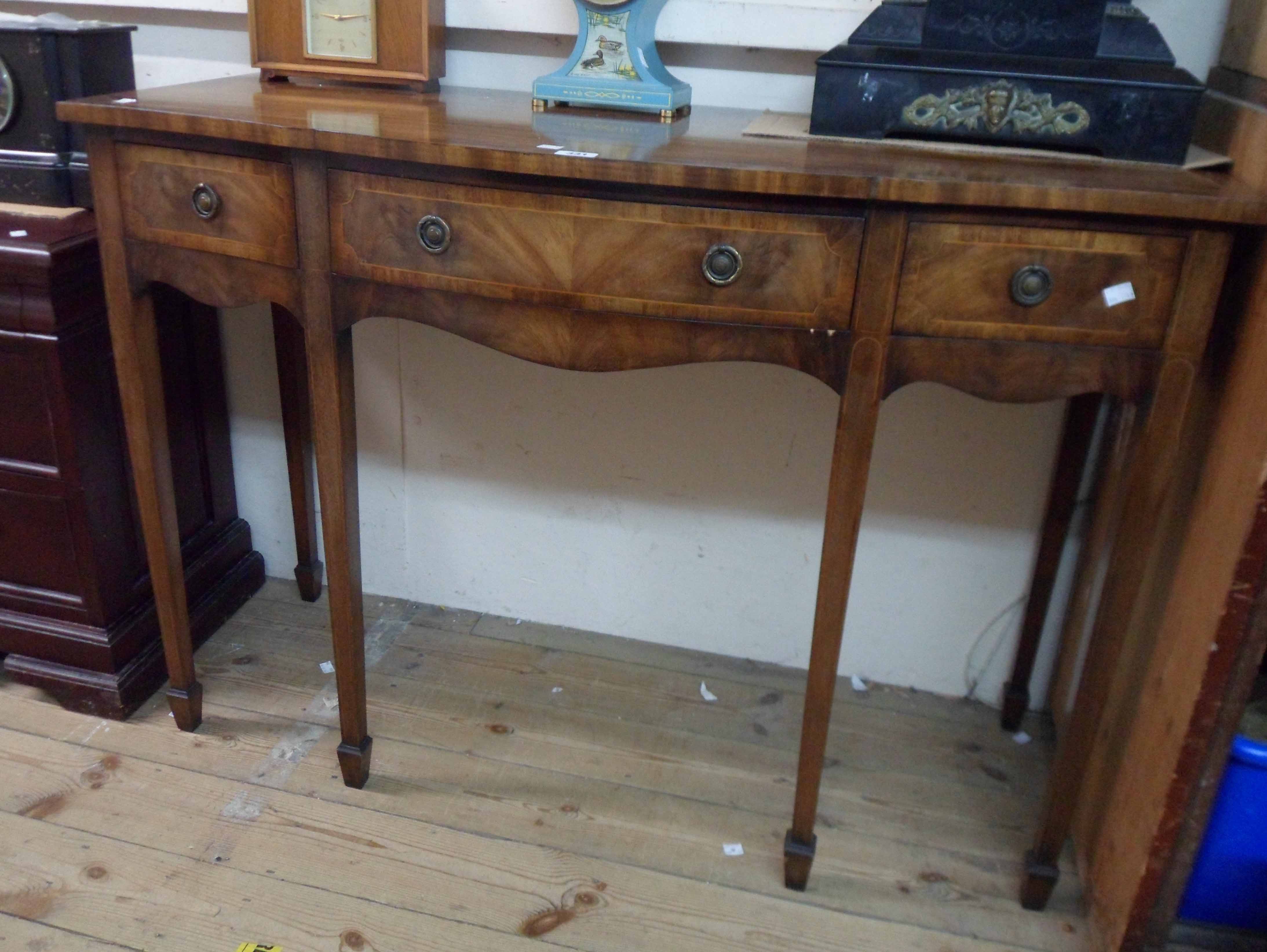 A 1.22m mahogany crossbanded and strung sideboard in the antique style with three frieze drawers,