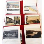 A box sleeved triple album collection of mainly early 20th Century local interest postcards