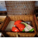 An old wicker picnic hamper and contents