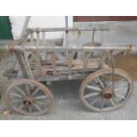 An old wooden dog cart with iron rims and spoked wheels - for restoration
