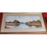 A gilt framed watercolour, depicting a panoramic river landscape with cottages in mid ground -