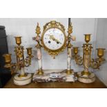 A 19th Century French ormolu and pink marble clock garniture, comprising a decorative drum dial