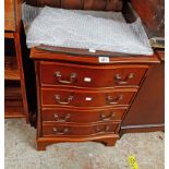 A 49.5cm reproduction yew serpentine front chest of four long graduated drawers, set on bracket