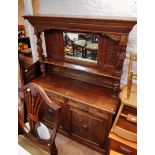 A 1.53m late 19th Century carved oak sideboard with high mirror set raised back with flanking male