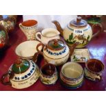 Ten pieces of Torquay ware including teapots, mugs, jugs, etc.