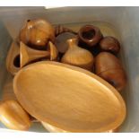 A box of carved wooden items including vases, boxes, eggs, etc.