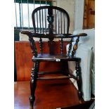 An early 20th Century stained elm and mixed wood Windsor bow elbow chair with high hoop stick back