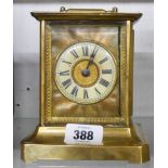 A late 19th Century brass and glazed case carriage style alarm clock with American musical movement