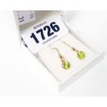 A pair of yellow metal mounted peridot drop ear-rings