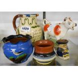An Aller Vale pottery puzzle jug and three further Torquay items - sold with a Staffordshire cow