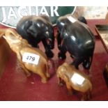 Four carved wooden elephant figures