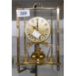 A vintage Kundo brass and bevelled glass cased anniversary clock with sphere pendulum