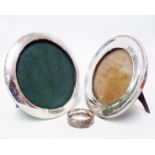 Two circular silver fronted photograph frames with easel backs - sold with a silver napkin ring