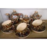 A Meiji period Japanese Satsuma six place tea service decorated with arhats and dragons,
