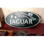 A modern reproduction painted iron Jaguar sign