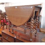 An 87cm 1920's oak gateleg table, set on barley twist supports
