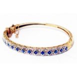An import marked 9ct. gold clasp bracelet, set with sapphires and small diamond in fitted case