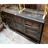 A 1.37m 20th Century oak sideboard with three frieze drawers and three panelled cupboard doors