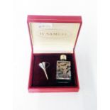 A hallmarked silver clad glass scent bottle with original filler funnel in H. Samuel box