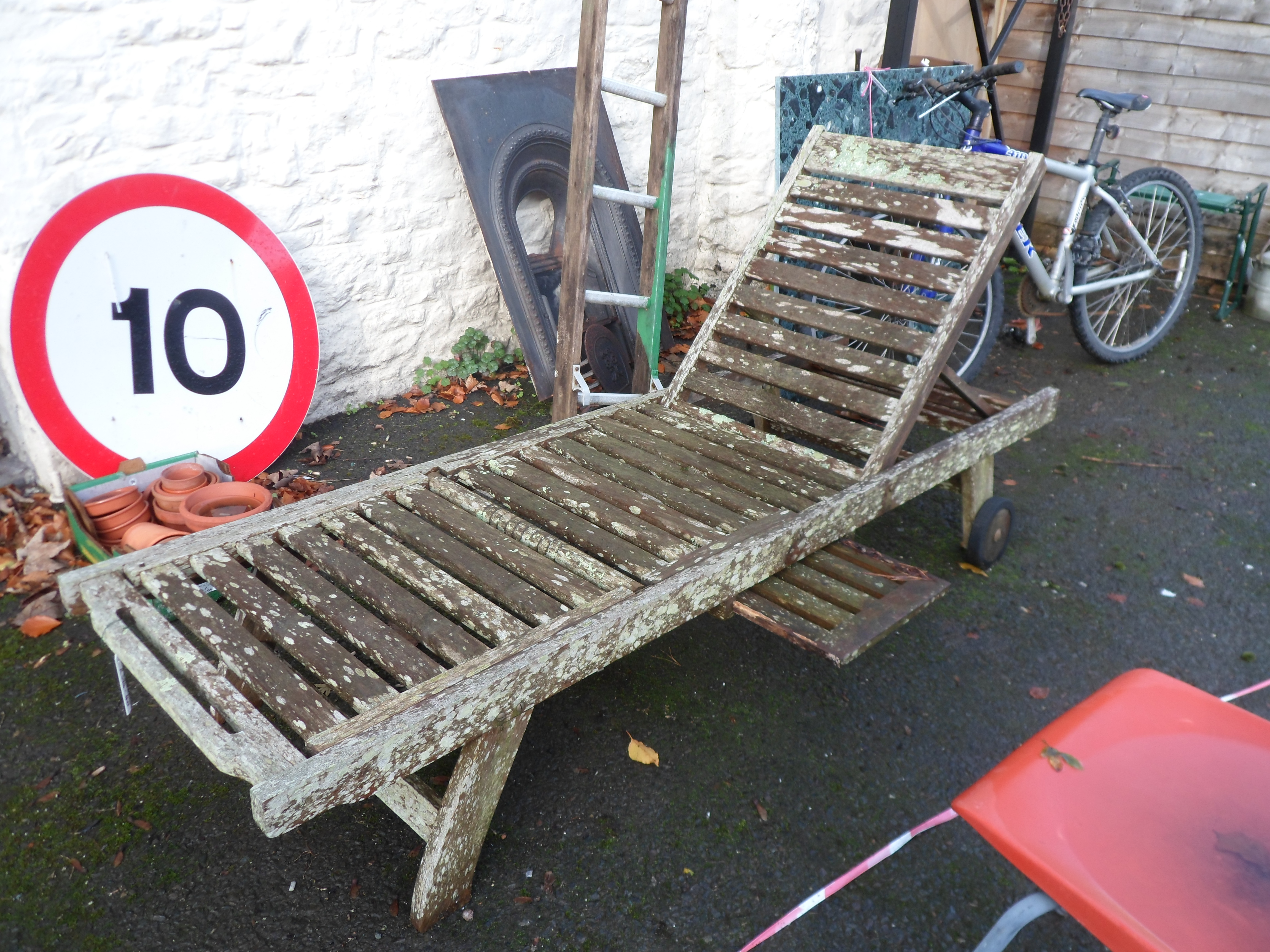 A teak sun lounger and cushions