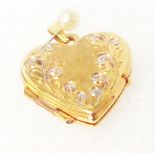 A marked 375 yellow metal heart shaped locket with decoration to front