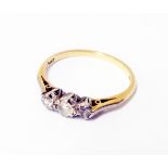 A marked 18ct yellow metal small three stone diamond ring