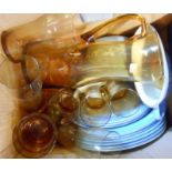 A box containing vintage opaque oven to table glassware and an amber glass lemonade set