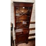 A 56cm 20th Century reproduction mahogany book cabinet with dentil cornice and shelves enclosed by