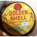 A reproduction painted cast iron Golden Shell Oil sign
