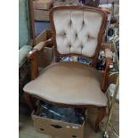 A reproduction stained wood framed elbow chair with studded button back upholstery, set on