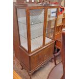 An 89cm flame mahogany veneered display cabinet with material lined interior and glass shelves