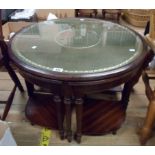 A 74cm diameter reproduction mahogany circular table with green leather inset top under glass and